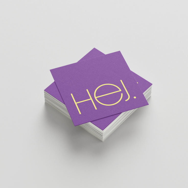 Rubrikfoto Designmanufaktur Zwei Karten auf Holzunterlage, eine lila und eine graue Karte.